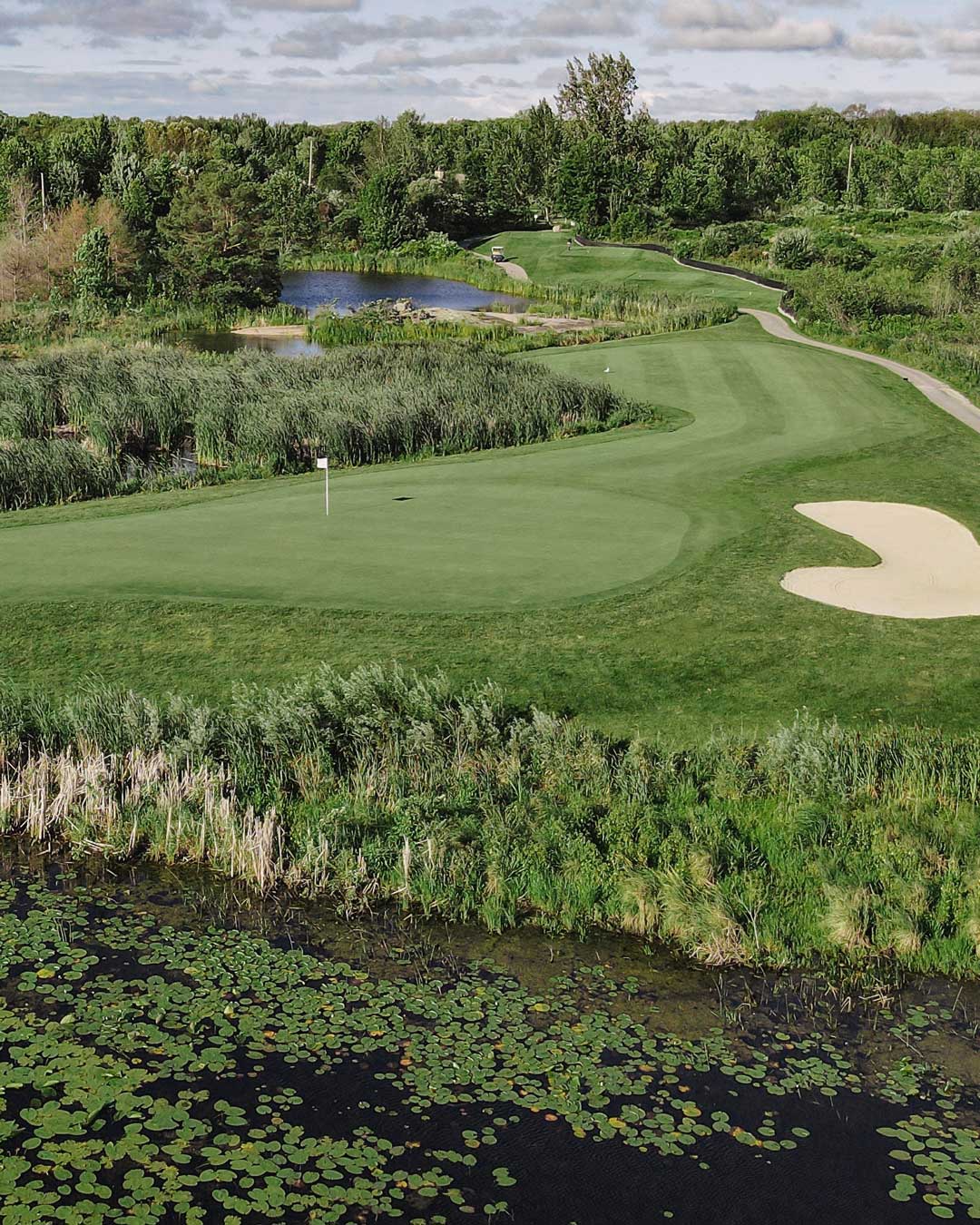 Muskoka golf green with water behind